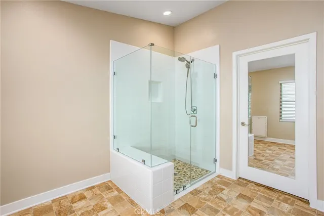 a bathroom with a granite countertop window and a shower