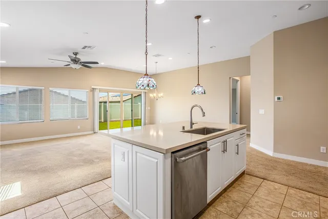 a kitchen with cabinets stainless steel appliances and a sink