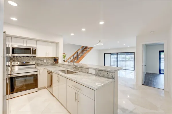 a kitchen with a sink stove and oven