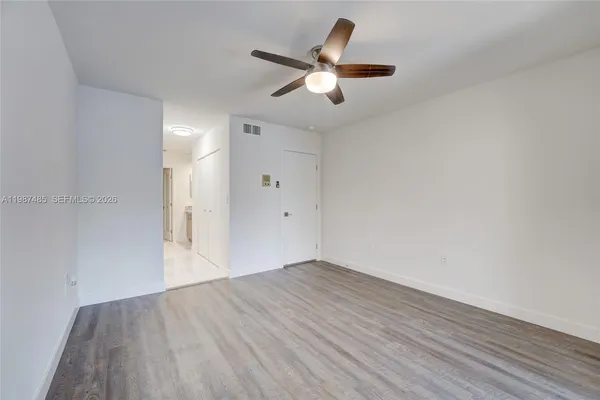 a backyard of a house with potted plants and large trees