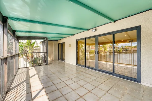 an aerial view of a city with lots of residential buildings ocean and mountain view in back