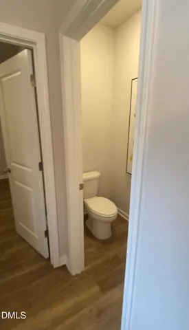 a bathroom with a white toilet and a shower