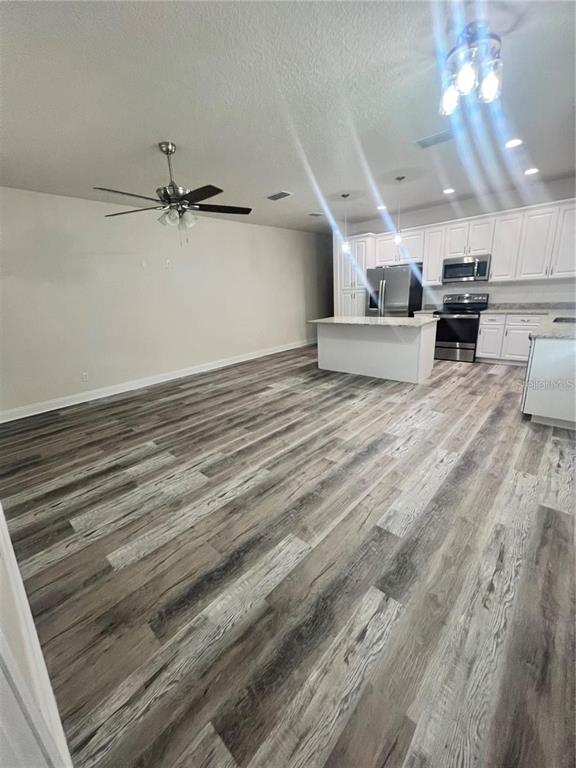 408 South Main Avenue Groveland, FL 34736 - Photo 4 of 15 a view of a livingroom with kitchen and furniture