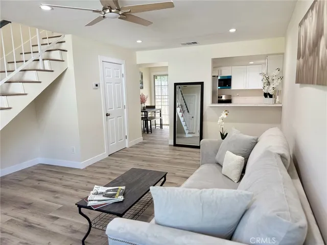 a living room with furniture and kitchen view