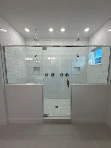 a white toilet sitting next to a white wall