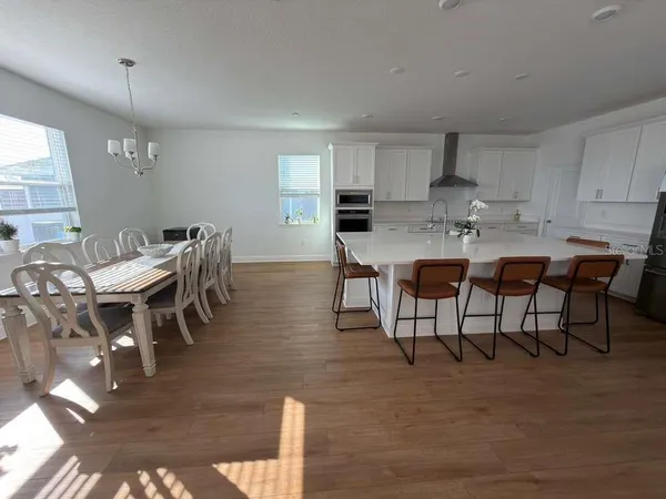a view of a dining room with furniture and wooden floor