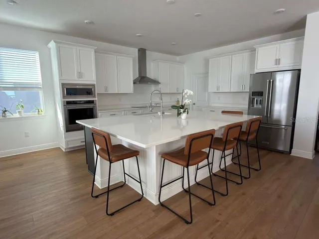 a view of a dining room with furniture and wooden floor