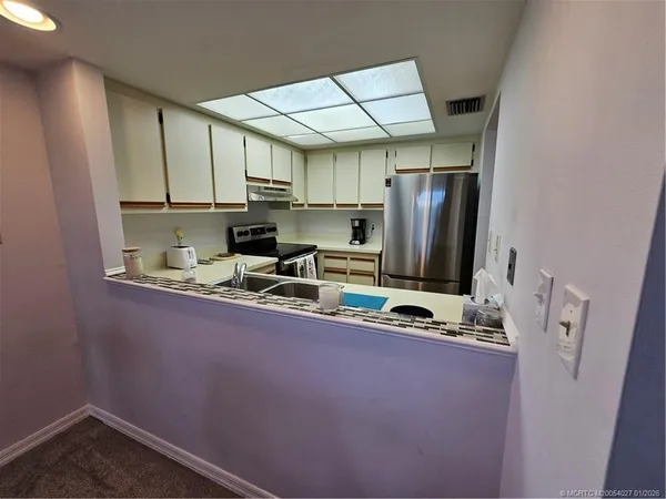 a kitchen with stainless steel appliances a sink stove and refrigerator