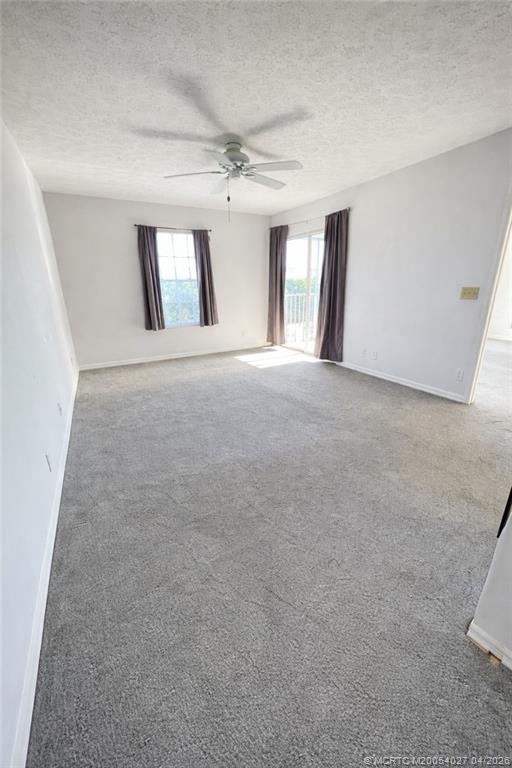 805 Southeast Central Parkway, Unit 16 Stuart, FL 34994 - Photo 4 of 11 a view of a big room with windows and chandelier fan