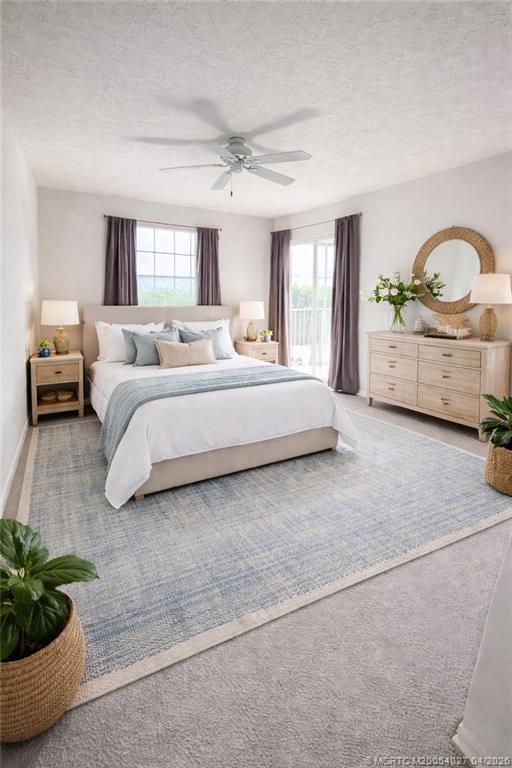 805 Southeast Central Parkway, Unit 16 Stuart, FL 34994 - Photo 5 of 11 a spacious bedroom with a bed a couch and potted plant