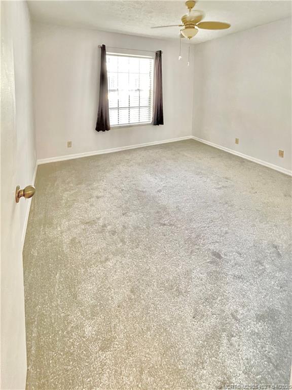 805 Southeast Central Parkway, Unit 16 Stuart, FL 34994 - Photo 6 of 11 an empty room with windows