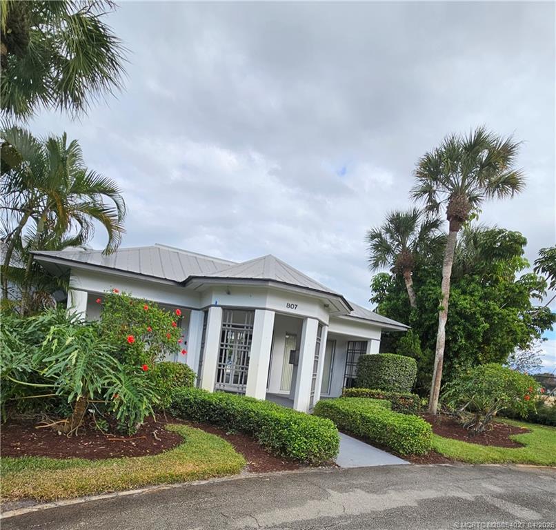 805 Southeast Central Parkway, Unit 16 Stuart, FL 34994 - Photo 10 of 11 a front view of a house with a garden