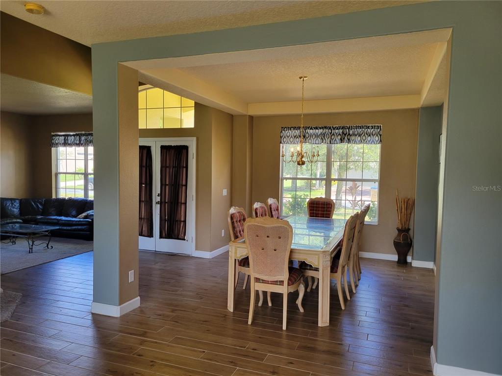 3145 Twisted Oak Loop Kissimmee, FL 34744 - Photo 20 of 93 a view of a dining room with furniture and wooden floor
