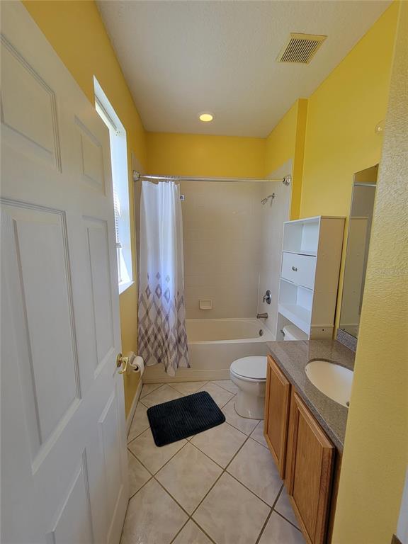3145 Twisted Oak Loop Kissimmee, FL 34744 - Photo 45 of 93 a bathroom with a sink a toilet a tub and shower