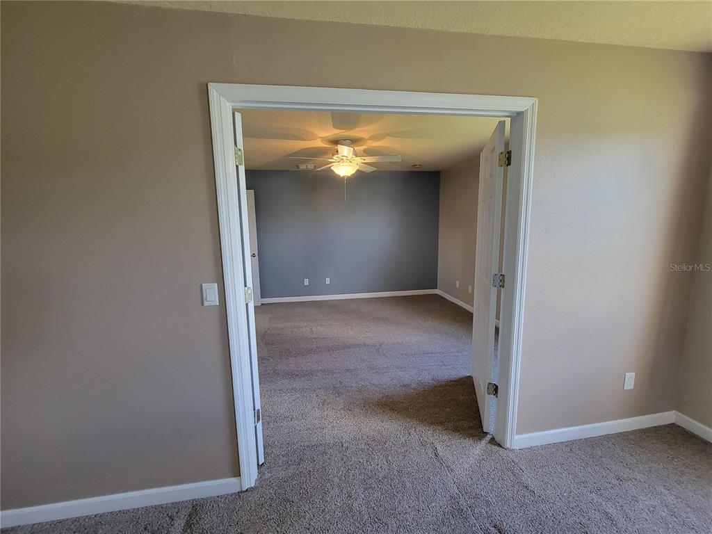 3145 Twisted Oak Loop Kissimmee, FL 34744 - Photo 76 of 93 a view of an empty room with a closet