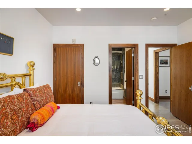 a bedroom with furniture and a rug