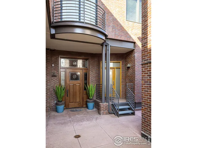 a view of a house with large windows and a small yard