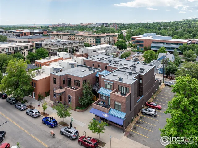 an aerial view of a house with a yard garage and lake view in back