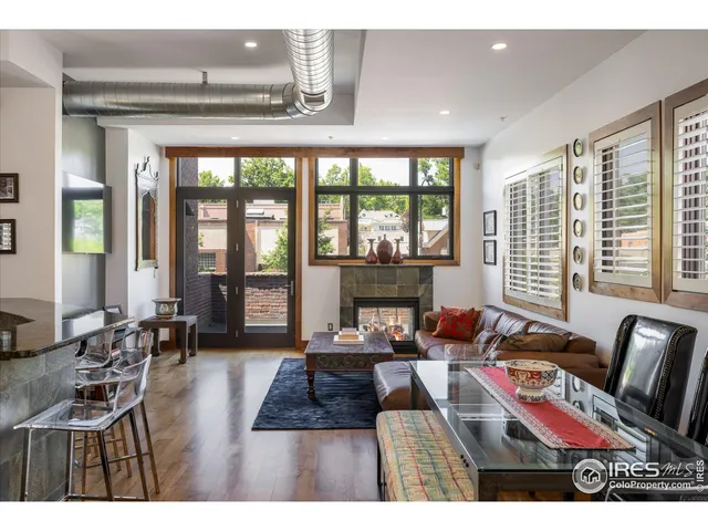 a living room with furniture and floor to ceiling windows