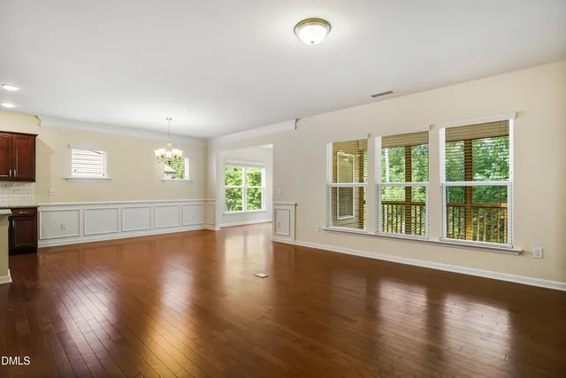 a large kitchen with stainless steel appliances granite countertop a refrigerator a sink and a stove