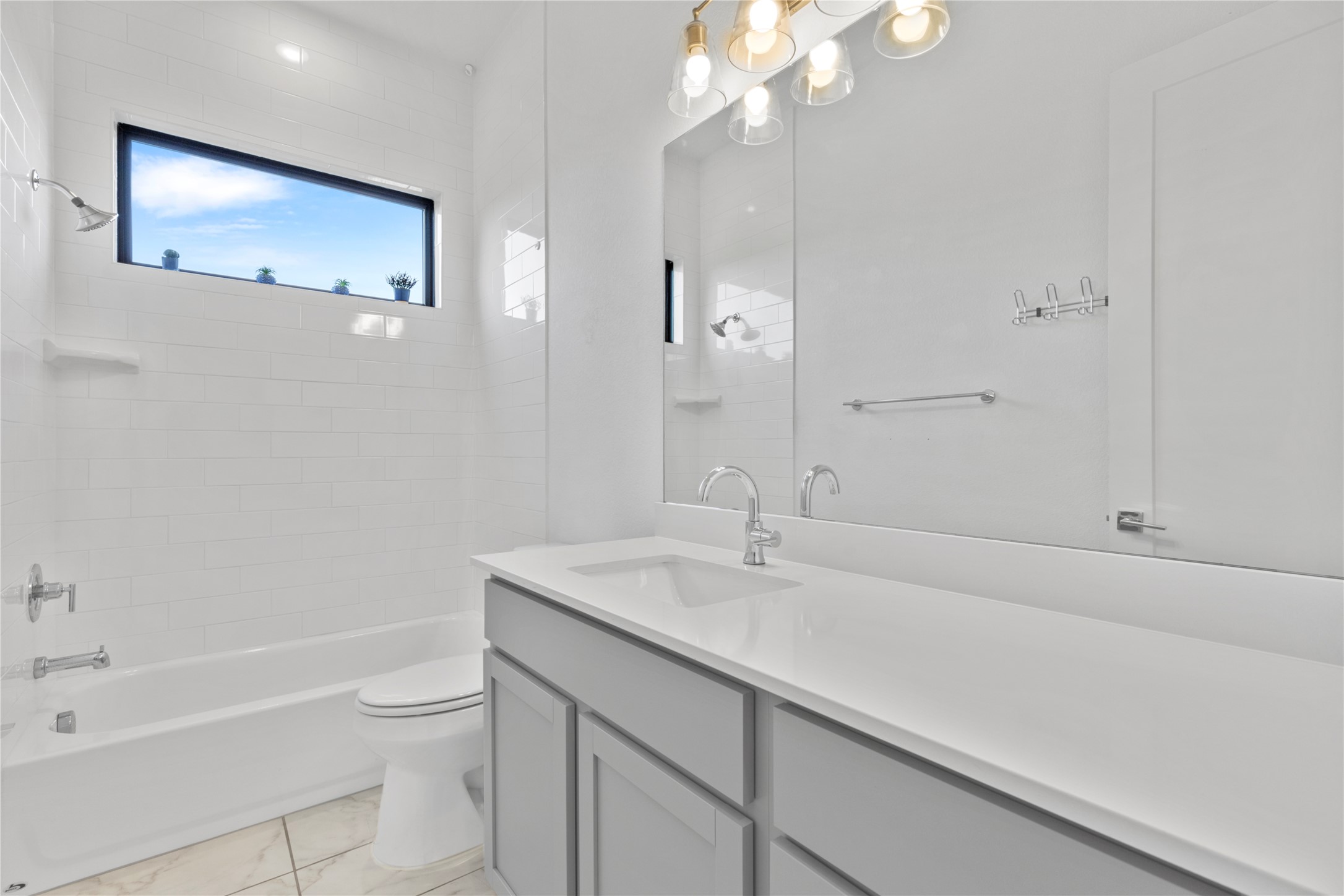 2050 Lohmans Spur Road, Unit 1302 Lakeway, TX 78734 - Photo 11 of 18 a bathroom with a sink a toilet and shower