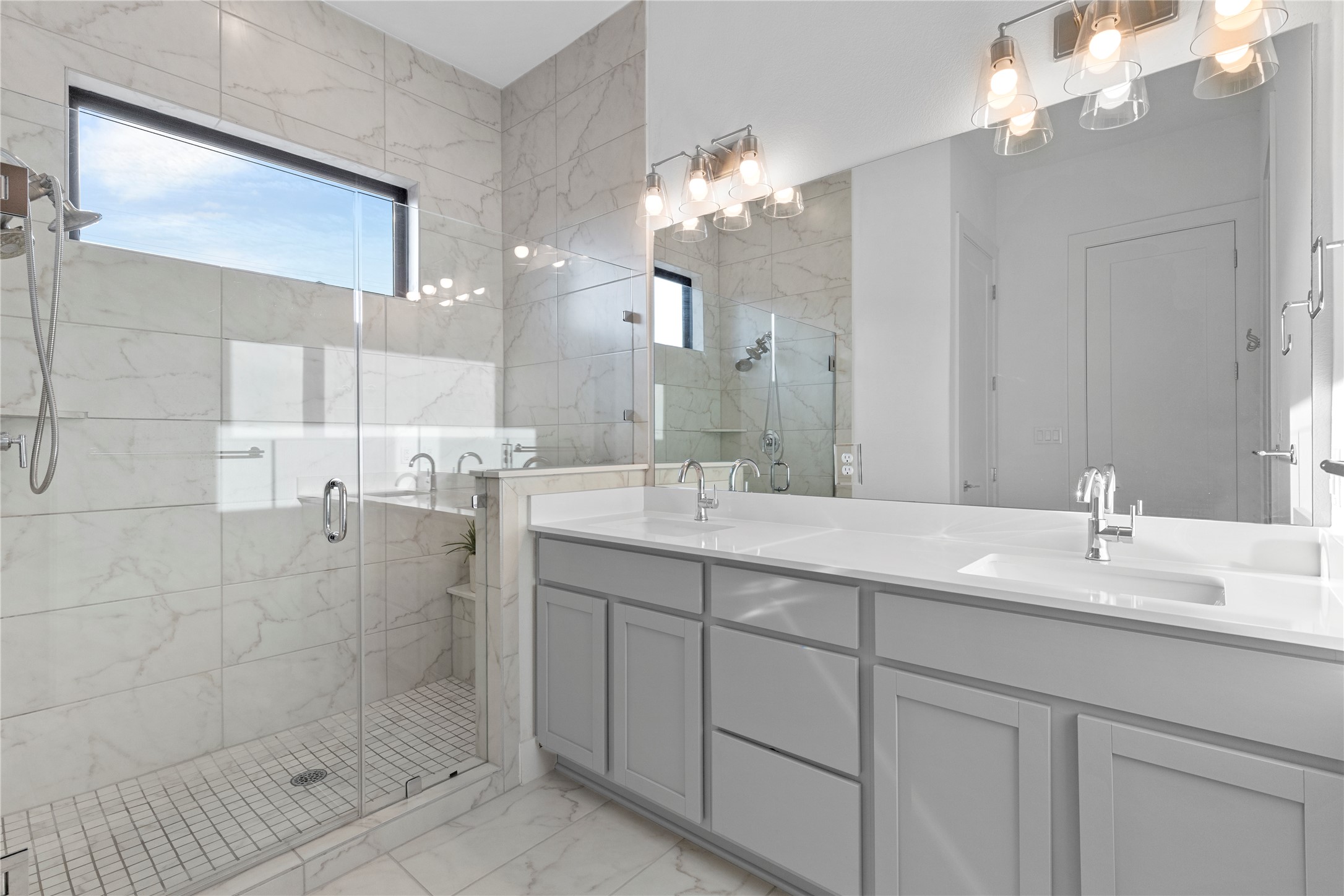 2050 Lohmans Spur Road, Unit 1302 Lakeway, TX 78734 - Photo 13 of 18 a bathroom with a double vanity sink mirror and shower