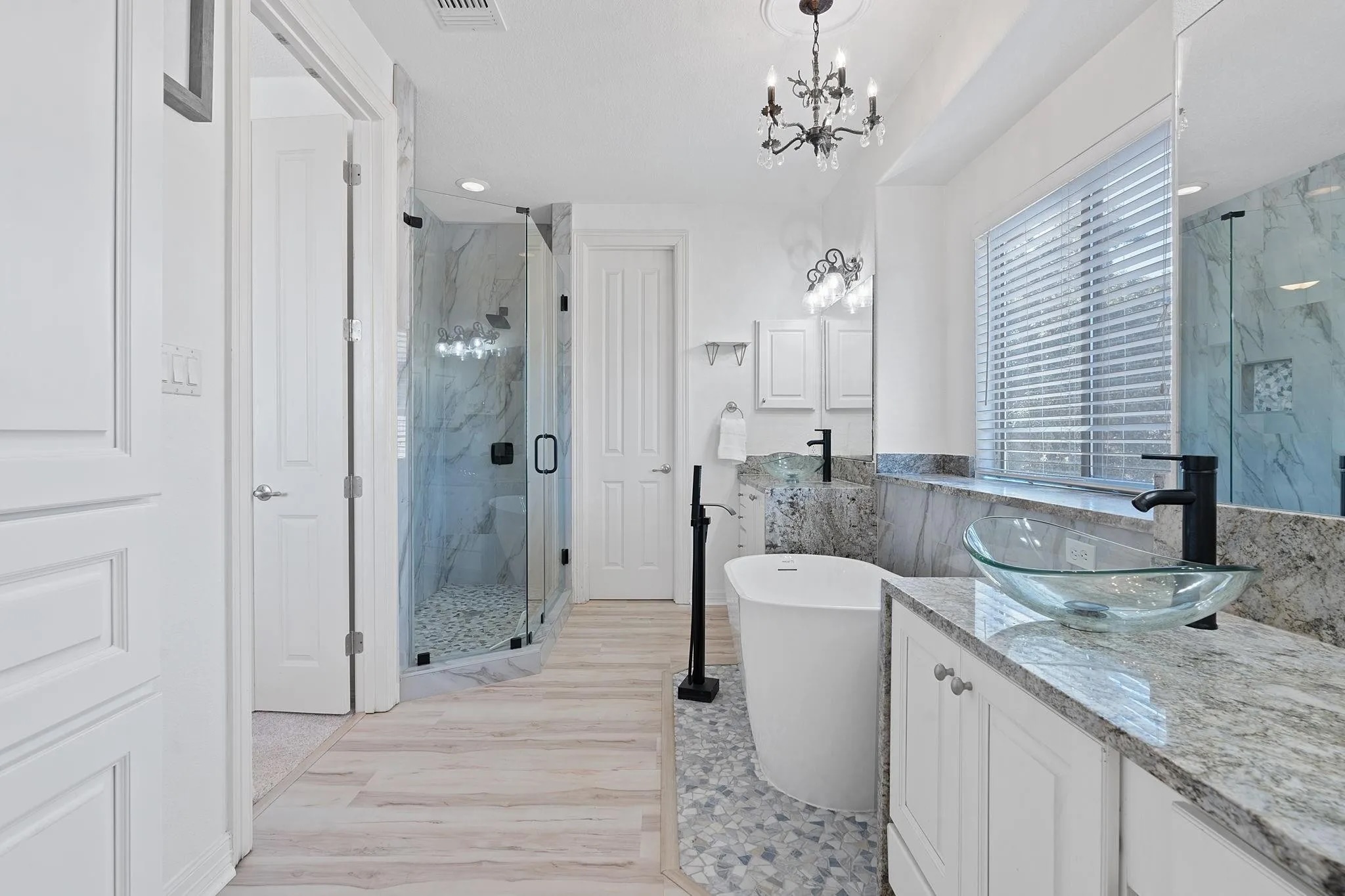 2050 Lohmans Spur Road, Unit 1302 Lakeway, TX 78734 - Photo 15 of 18 a bathroom with a granite countertop sink a mirror and shower