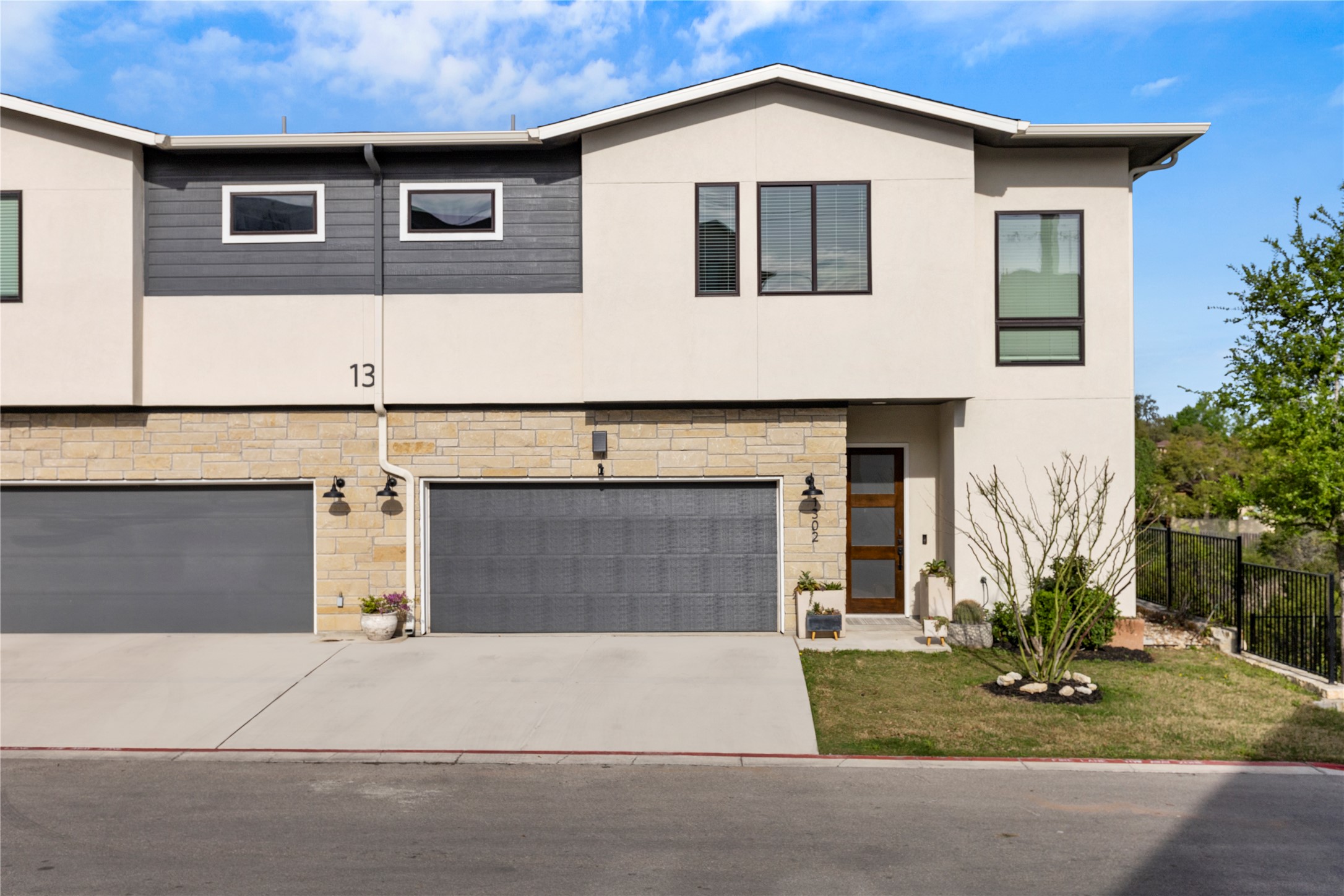 2050 Lohmans Spur Road, Unit 1302 Lakeway, TX 78734 - Photo 17 of 18 a front view of a house with garage