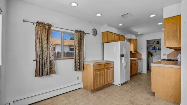 a kitchen with stainless steel appliances a refrigerator and a stove top oven
