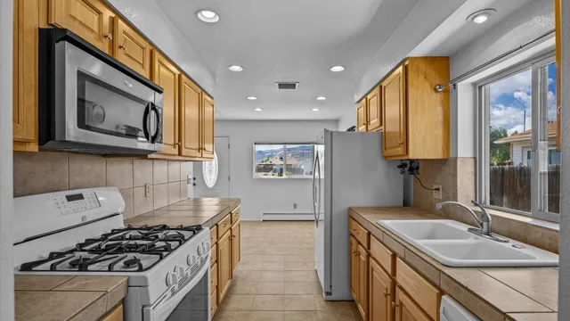 a kitchen with stainless steel appliances a stove a sink and a microwave