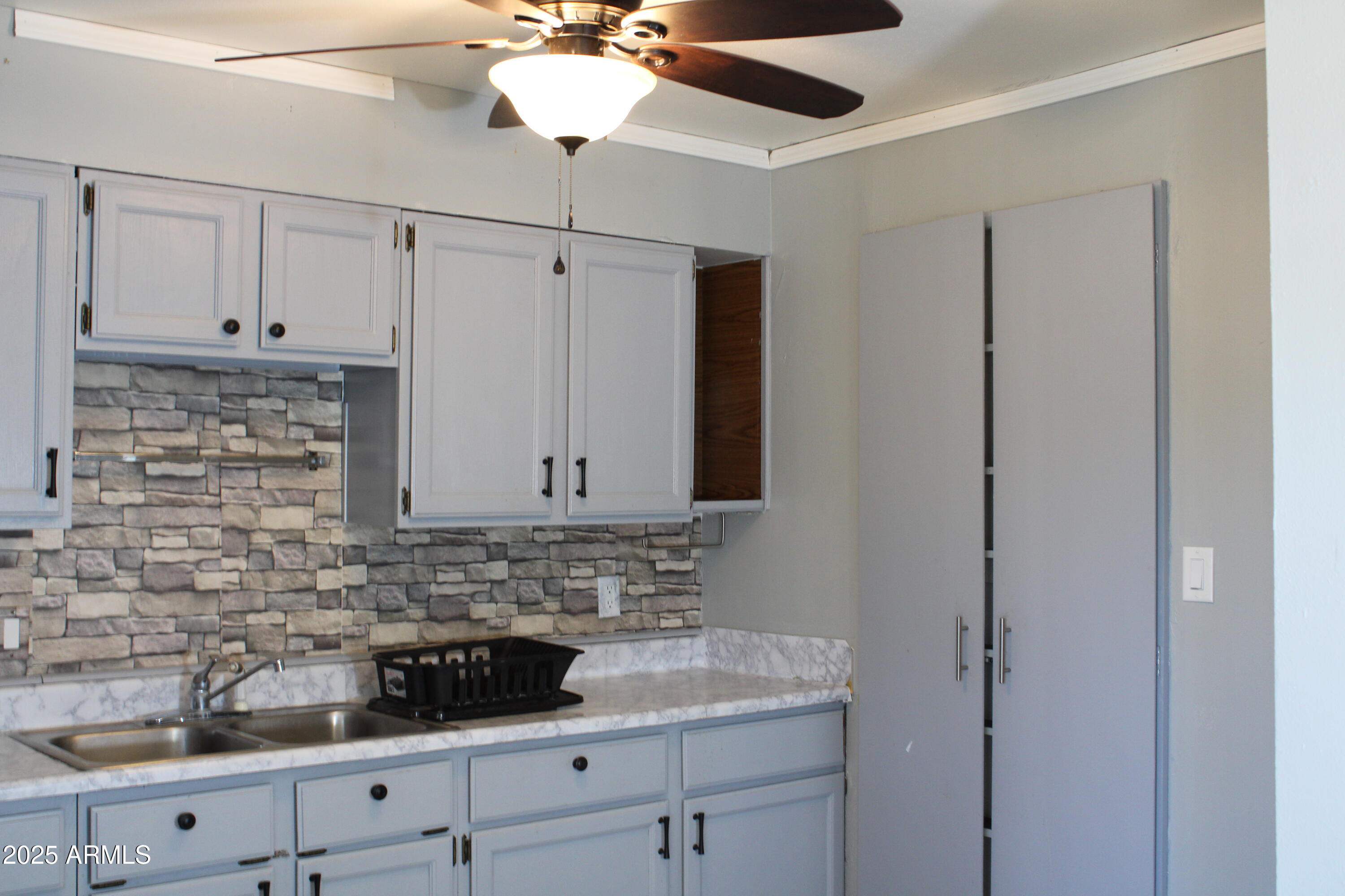 336 Greenwich Road Kearny, AZ 85137 - Photo 6 of 37 a kitchen with stainless steel appliances white cabinets and a sink
