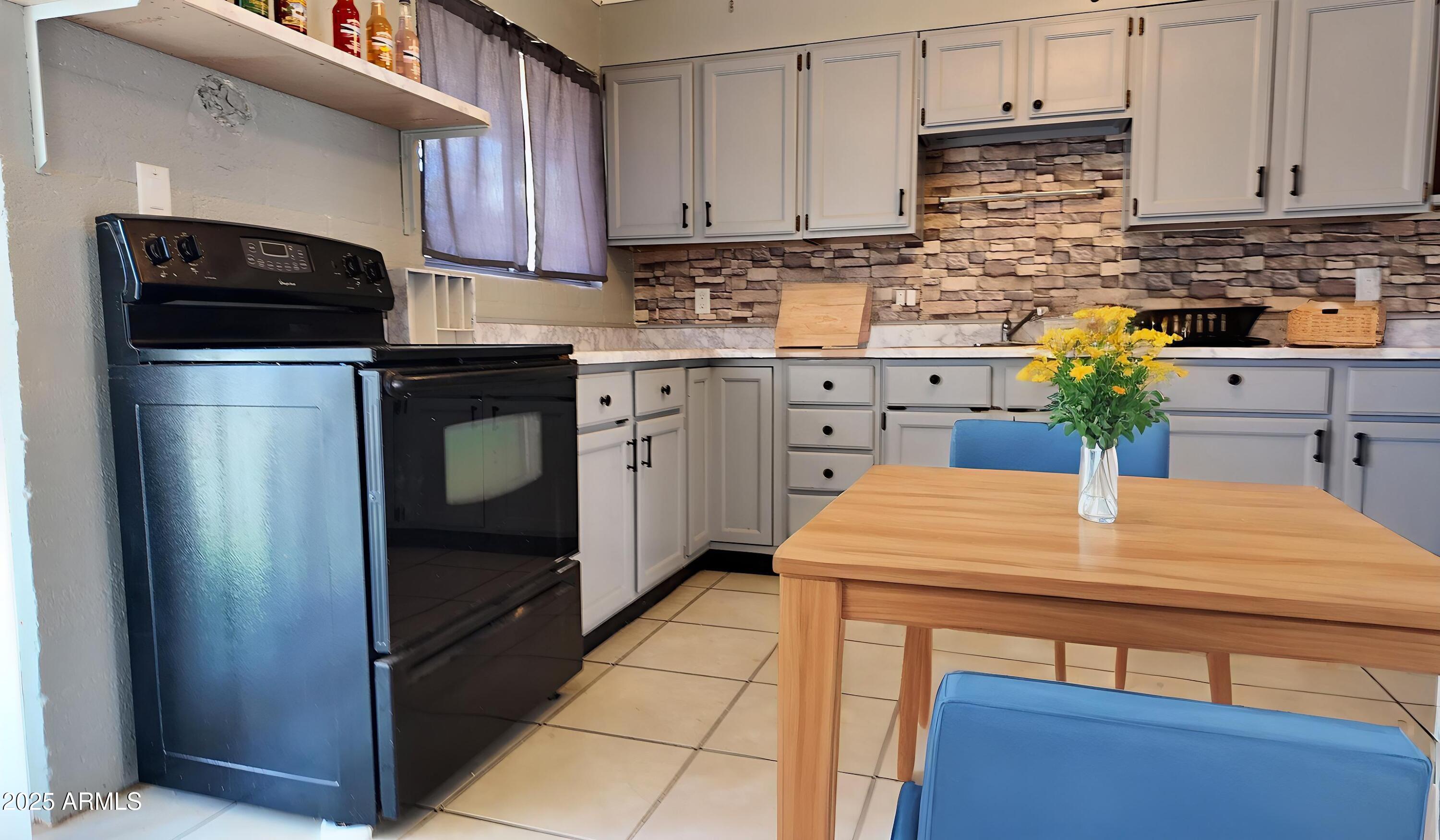 336 Greenwich Road Kearny, AZ 85137 - Photo 7 of 37 a kitchen with stainless steel appliances kitchen island a refrigerator sink and cabinets