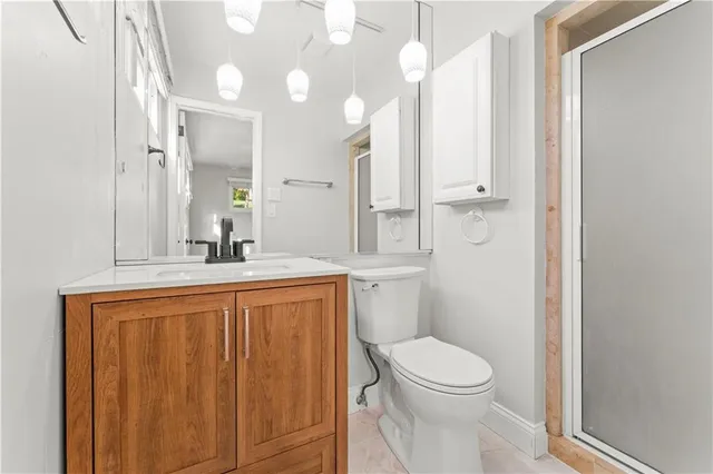 a bathroom with a toilet a sink and a mirror