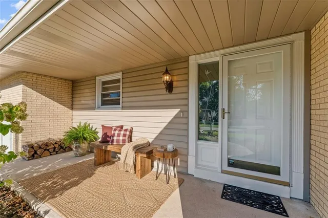a view of a patio with table and chairs and potted plants