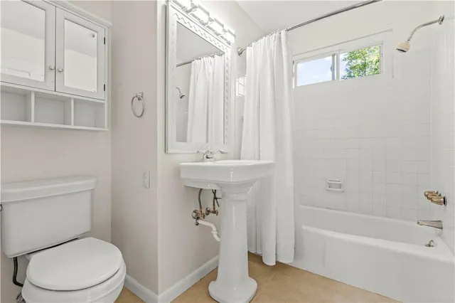 a bathroom with a sink a toilet and bathtub