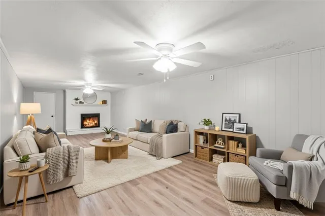 a living room with furniture a fireplace and a chandelier
