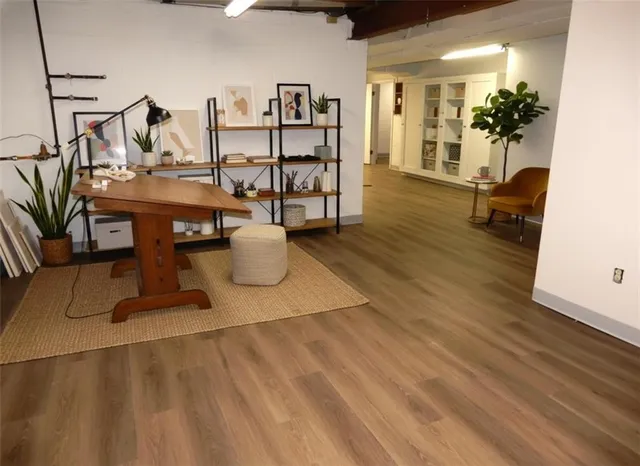 a living room with furniture a chandelier and wooden floor