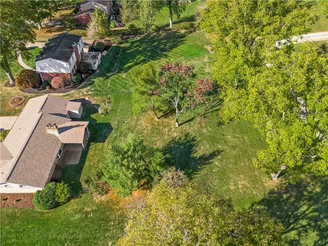 an aerial view of residential house with green space