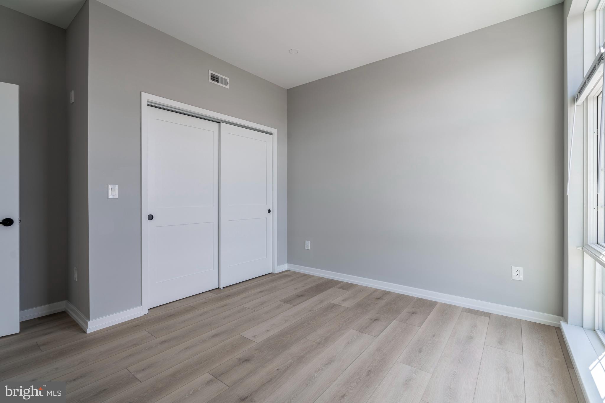 2401 Washington Avenue, Unit 3D Philadelphia, PA 19146 - Photo 11 of 18 a view of an empty room with wooden floor