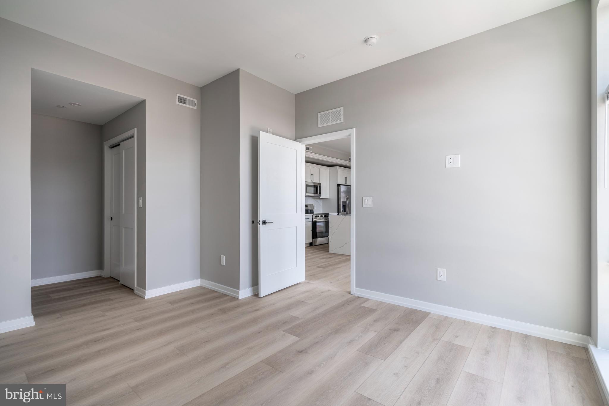 2401 Washington Avenue, Unit 3D Philadelphia, PA 19146 - Photo 15 of 18 a view of an empty room with wooden floor and closet