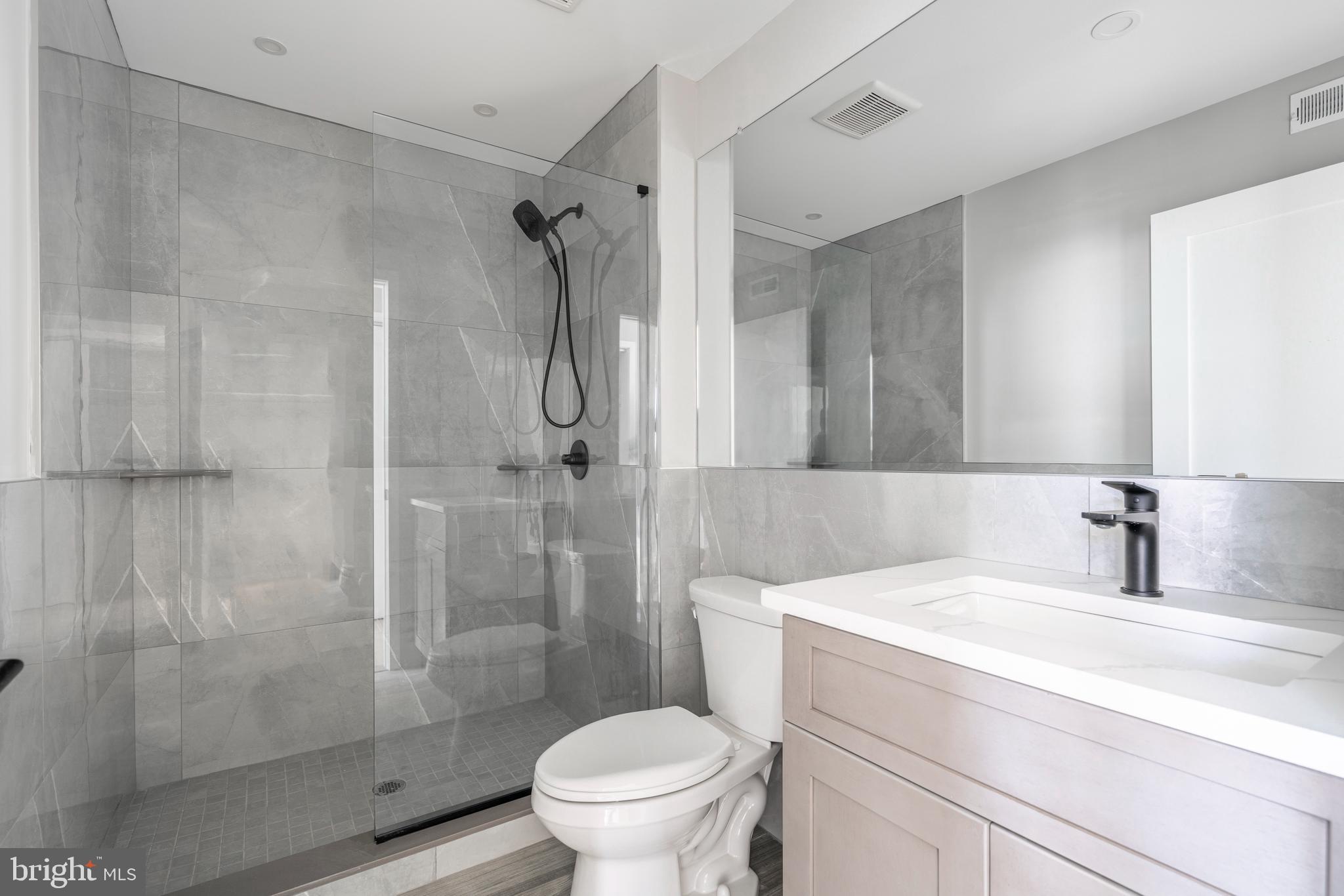 2401 Washington Avenue, Unit 3D Philadelphia, PA 19146 - Photo 17 of 18 a bathroom with a sink toilet and shower