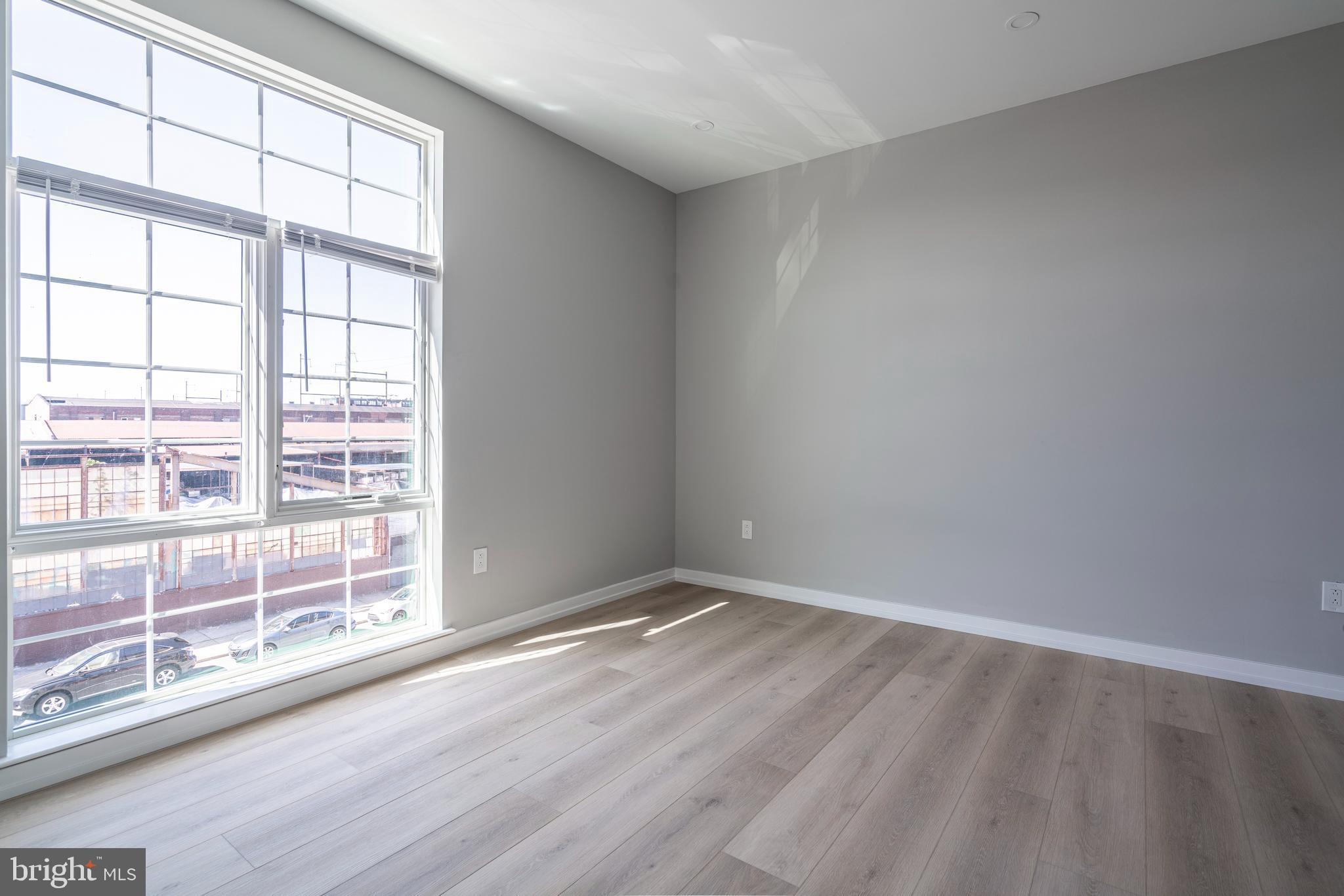 2401 Washington Avenue, Unit 3D Philadelphia, PA 19146 - Photo 18 of 18 wooden floor in an empty room with a window