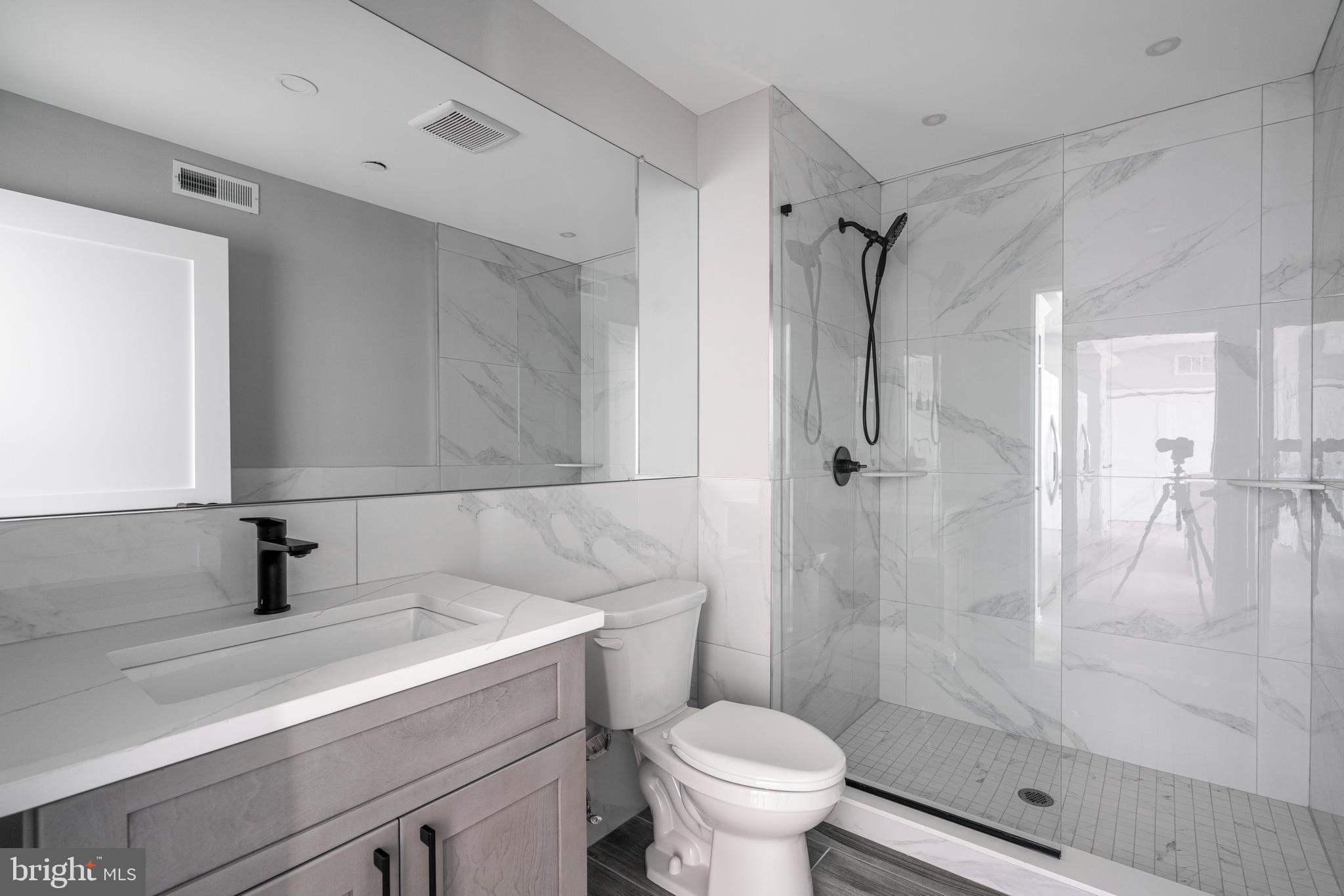 2401 Washington Avenue, Unit 3D Philadelphia, PA 19146 - Photo 6 of 18 a bathroom with a sink toilet and shower