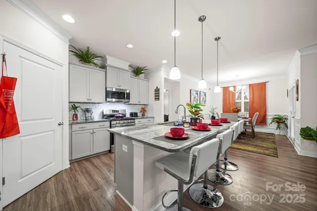 a kitchen with white cabinets and counter space