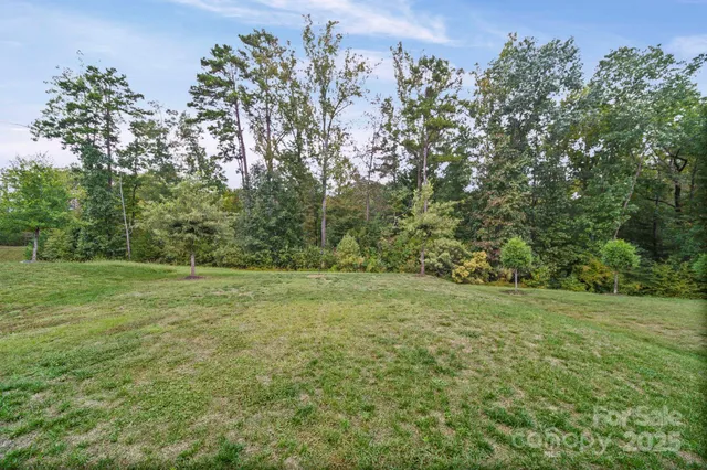 a backyard of a house with chairs and garden