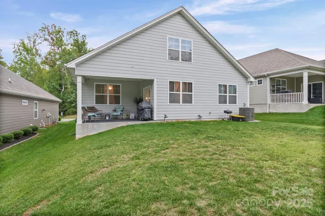 a view of backyard with a table and chair under an umbrella
