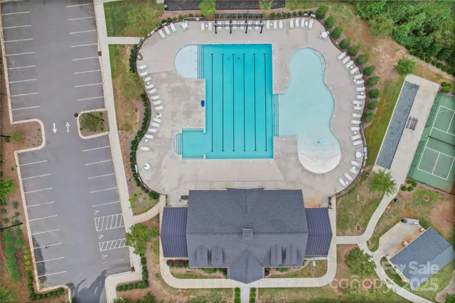 an aerial view of a house with a swimming pool