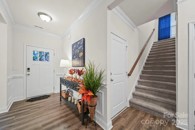 a view of entryway with stairs and wooden floor