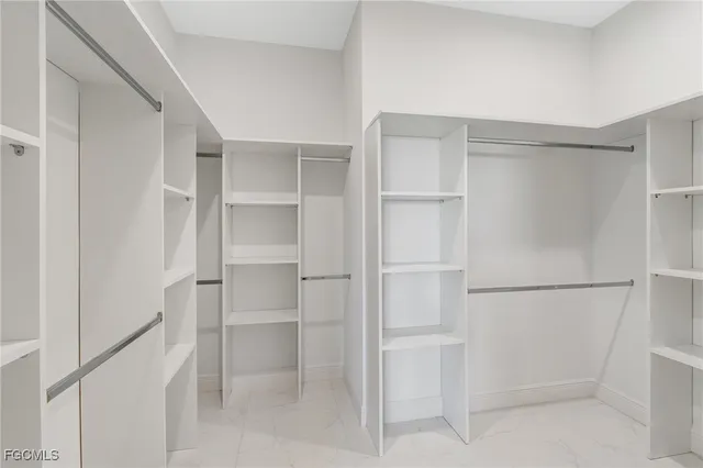 a walk in closet with empty racks
