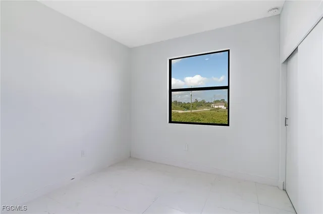 an empty room with window and wall painting